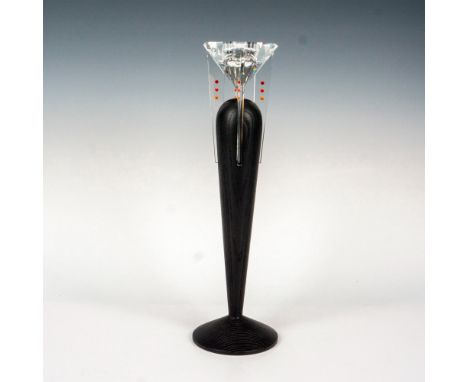 The candle holder is a sleek, narrow design in black, with a removable faceted crystal ball adorned with small fire-colored c