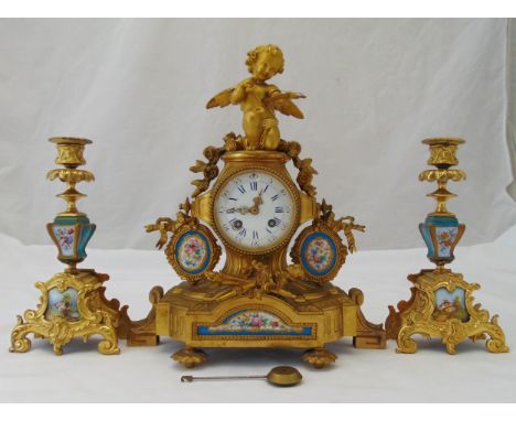 A French 19th century mantle clock comprising a gilt metal and porcelain clock with white enamel dial with Roman numerals, su