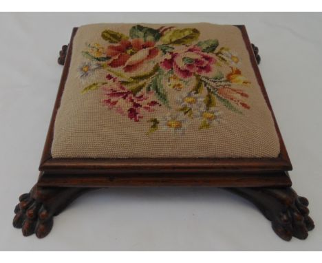 A William IV square mahogany footstool with tapestry upholstery on lion claw feet, 13 x 42 x 42cm