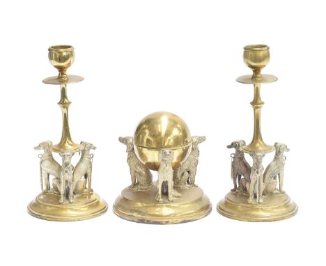 A pair of 19th century French brass candlesticks, the flared stem on a circular base with three seated whippets, each 18cm hi