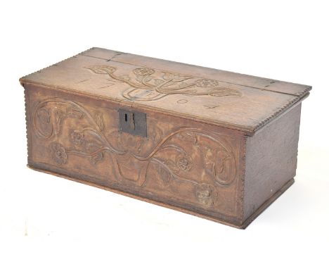 A small carved oak trunk, with shield and foliate design, he lid inscribed 'IP 1704', 77cm wide, 40cm deep, 30cm high