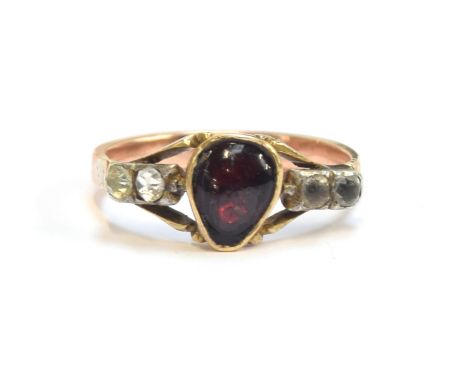 A late 18th century Georgian heart ring set with a central garnet flanked by paste, trifurcated shoulders, with a rayed baske