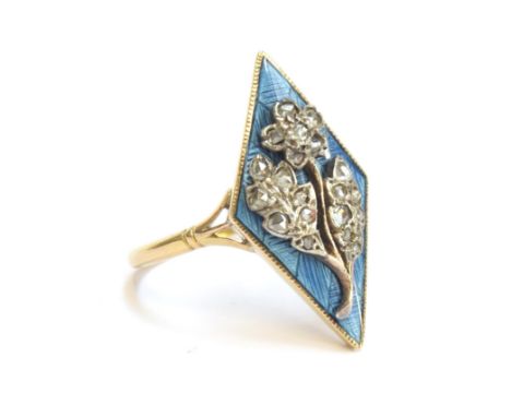 An 18ct gold late 19th/early 20th century ring, blue enamel lozenge panel set with a diamond encrusted floral spray, trifurca