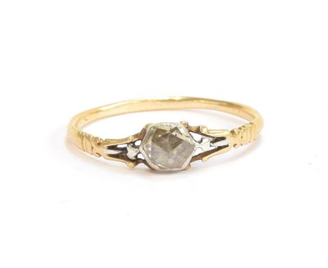 A late 18th century diamond solitaire ring set with a rose cut diamond in a rayed basket back setting and trifurcated shoulde