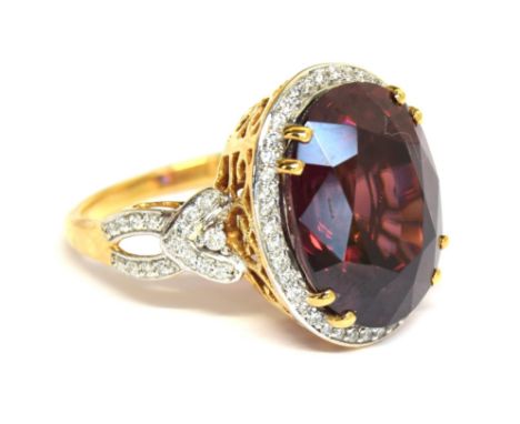 An 18ct gold, red zircon and diamond ring, the large Ratanakiri red zircon 17.9cts and measuring 16x12mm, size O, gross weigh