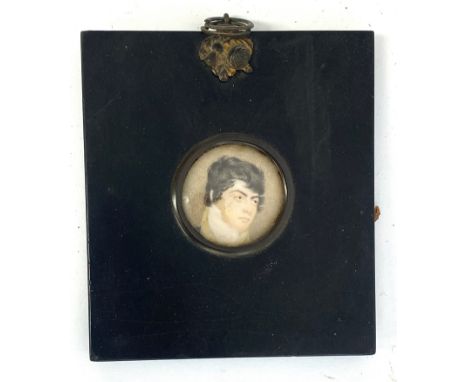 An Regency portrait miniature of a handsome young man, in ebonised frame, 3.6cm diameterProvenance: from the estate of the la