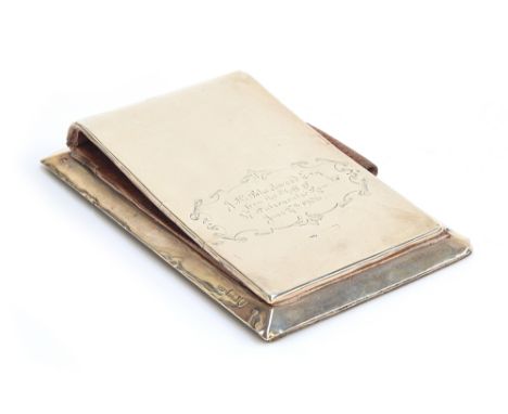 An Edwardian silver desk jotter, marks rubbed, inscribed with dedication; together with a small twin handled trophy on turned