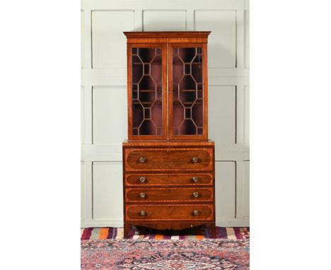 A mahogany and cross banded bureau bookcase c.1820 and later, with astragal glazing above a secretaire drawer enclosing a fit