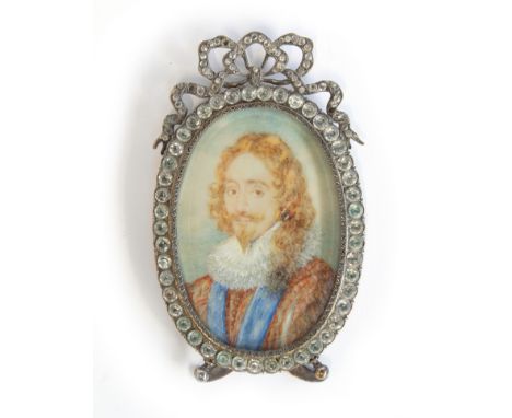 A 19th century portrait miniature on ivory of Charles I, in a silver plated frame with ribbon cresting set with paste, with b