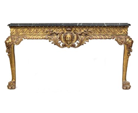 An 18th century side table in the manner of Matthias Lock, serpentine marble top, over a giltwood frieze carved with central 