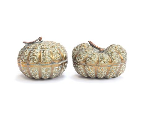 Two Cambodian ornately chased brass betel nut boxes in the form of gourds with copper 'stem' handles, 10cm and 11cm wide