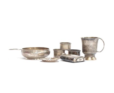 A small mixed lot of silver, to include a tastevin by Adderley Bros, Birmingham 1939; three napkin rings; a small mug; a hear