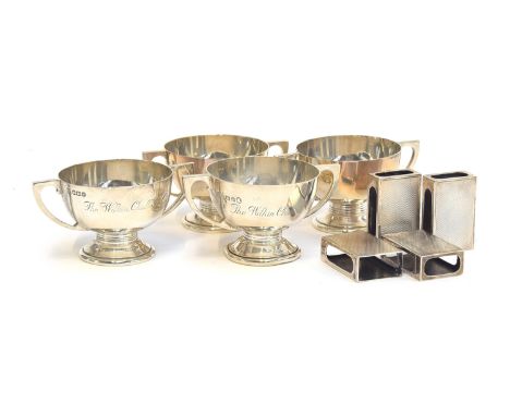 A set of four engine turned silver matchbox sleeves by Mappin &amp; Webb; and set of four miniature silver trophy cups by Nor