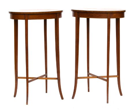 A pair of Edwardian mahogany lamp tables, oval, each with central shell patera, on four square tapered swept legs joined by a
