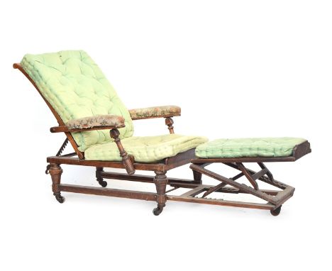 A 19th century reclining open armchair, with a pull out adjustable footstool, caned back, seat, and stool, with three button 