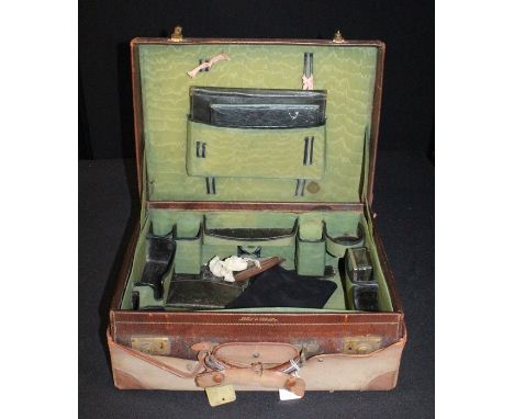 Mappin &amp; Webb gentleman's leather vanity case, the canvas protective exterior opening to reveal a brown leather case embo