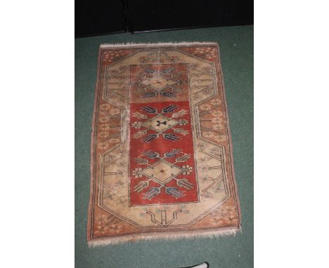 Middle Eastern carpet, the brick red ground surrounded by foliate borders, 79cm x 119cm