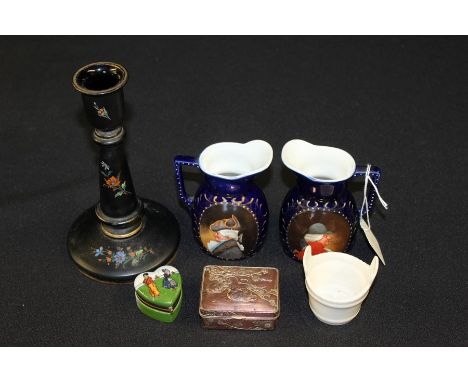 Floral decorated candlestick, two blue porcelain jugs with caricature decoration, Goss model of a Norwegian bucket etc. (qty)