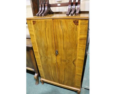 Edwardian walnut gentleman's wardrobe, the two simulated panelled cupboard doors opening to reveal an interior shelf above fi