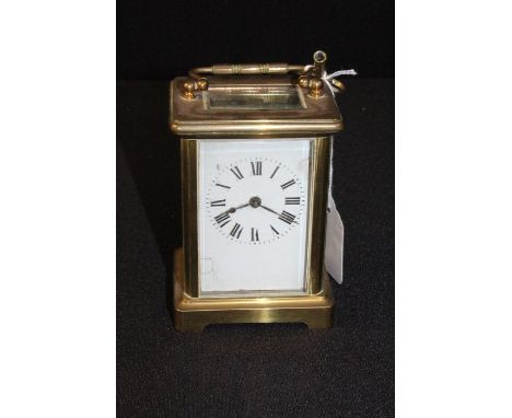 Gilt brass French carriage clock, with a white enamel dial with Roman hours