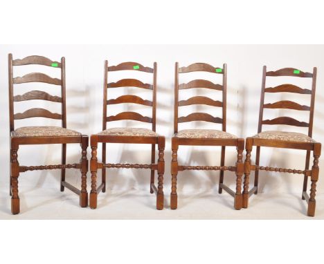 A set of 4 20th Century ladder back dining chairs. Having an arched top with four horizontal supports, drop in floral upholst