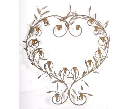 A contemporary designer wire worked heart shaped candelabra having leaves interspersed with gilt candlestick holders having f