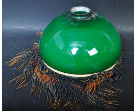 A retro vintage mid 20th century green glass light shade having a band of beaded polychrome tassels to the rim. Measures 23cm