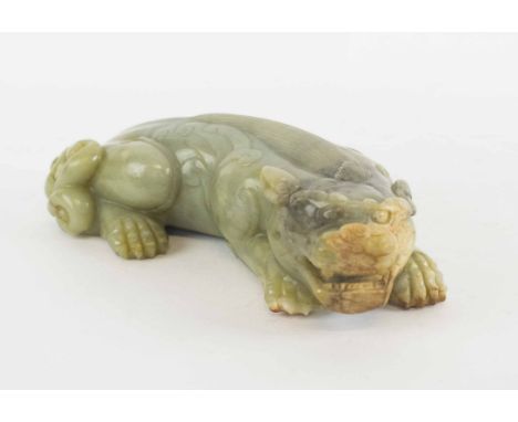 A LARGE CHINESE CARVED CELADON COLOURED JADE KYLIN, with russet inclusions, 23cm L. 