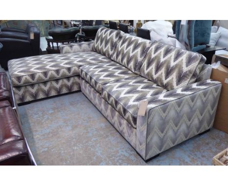 CORNER SOFA, in a geometric patterned fabric on block supports, 260cm x 180cm.