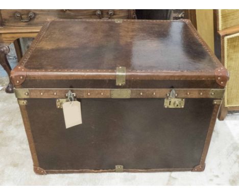 TRUNK, brown leather with a rising lid and brass detail, 81cm W x 62cm D x 58cm H. 