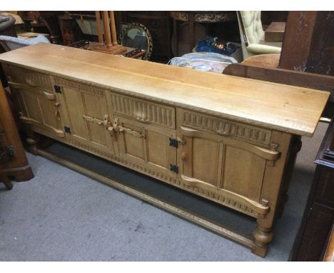 A light oak sideboard with panelled doors, approx 198cm x 40cm x 76cm. Shipping category D.