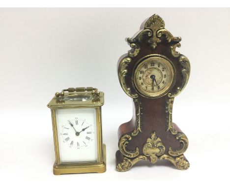 A brass cased carriage clock and a small mahogany and a small gilt cased mantle clock (2).