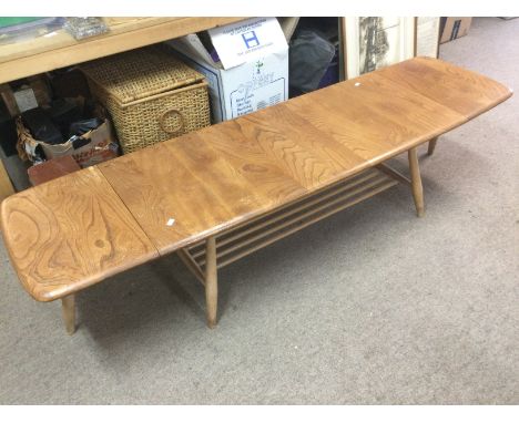 An Ercol drop leaf table, approx 160cm when extended. Shipping category D.