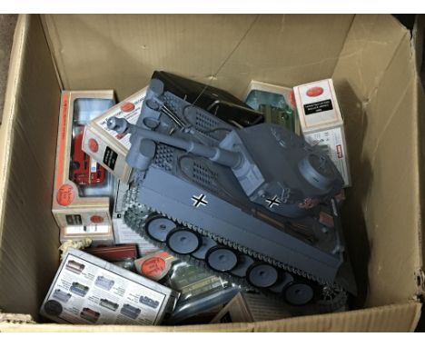 A box containing Gilbow scale model die cast busses and a remote control model of a tank.