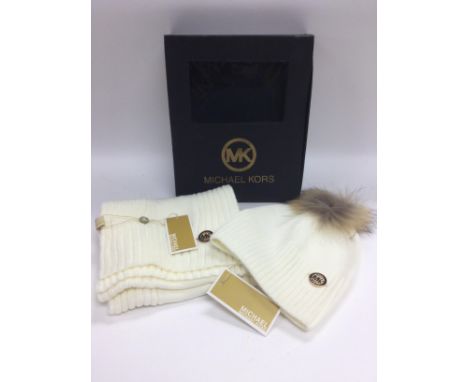 A boxed Michael Kors hat and scarf set. Shipping category B.
