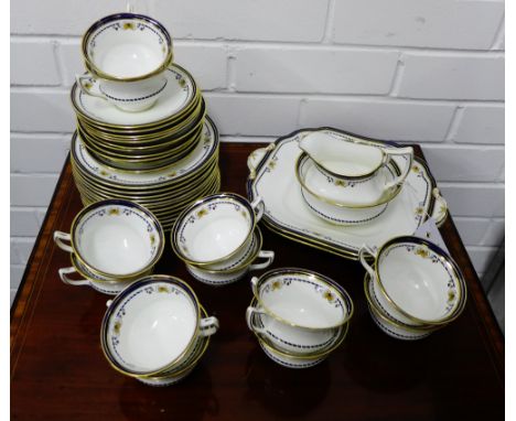 An Aynsley white glazed china teaset with blue borders and gilt rims, comprising twelve cups, twelve saucers, twelve side pla