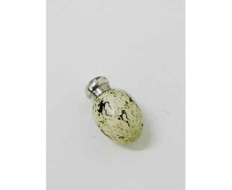 A Victorian novelty ceramic and silver mounted scent bottle modelled as an egg, very much in the manner of James McIntyre, wi