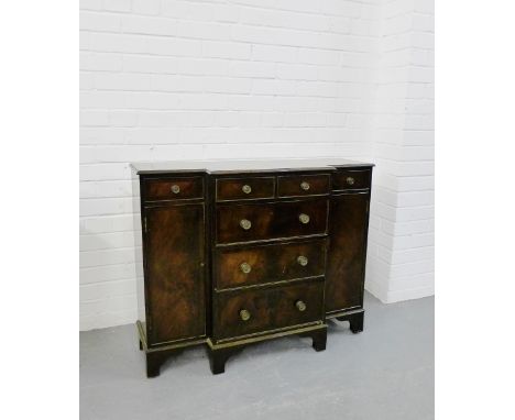 A mahogany breakfront side cabinet with two short drawers over three long, flanked by cupboard doors to each pedestal on brac