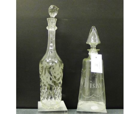 An etched glass whisky decanter and stopper, together with a vine leaf engraved decanter and stopper, tallest, 35cm, (2) 