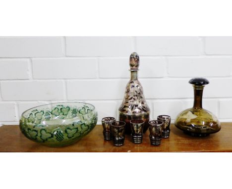 A silver overlay on aubergine glass decanter set, together with a smoked glass decanter with fish pattern and a green painted