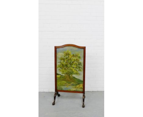 A mahogany fire screen with a tapestry insert depicting a tree and river landscape, 103 x 54cm