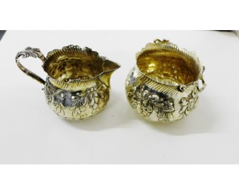 A Victorian silver floral embossed cream jug and basin of cauldron form, with makers mark for Charles Stuart Harris, London 1