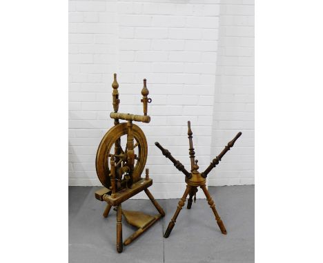 A country wood spinning wheel, 97cm high, together with a turned wood tripod base, (2) 