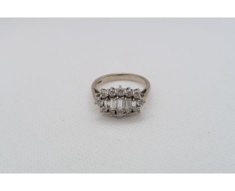 A striking round baguette and round brilliant cut diamond cluster ring - The five central graduated baguette cut diamonds set