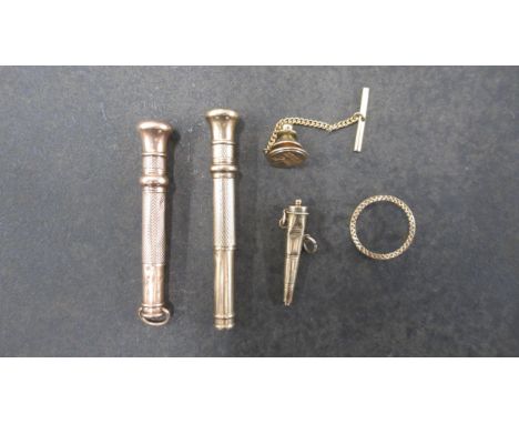 Two 9ct (hallmarked) cigar piercers, 6.5cm and 5.5cm, together with a 9ct gold (tested) conical vinaigrette, badge and coin f