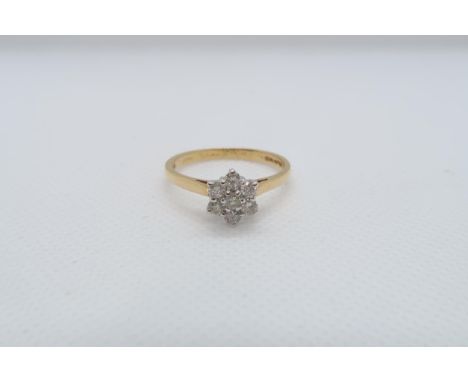 An 18ct yellow gold (hallmarked) and diamond daisy cluster ring size V - approx weight 3.7 grams 