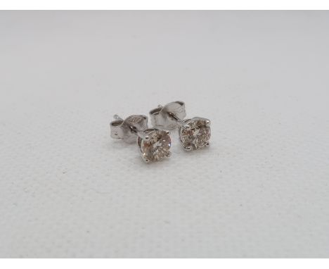 A pair of single stone diamond stud earrings - studs set in 18ct white gold - each round brilliant cut diamond approx 5mm dia