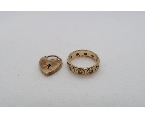A 9ct yellow gold (hallmarked) band ring size N and a 9ct (hallmarked) heart lock - total weight approx 6.1 grams 