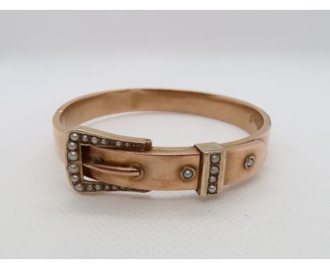 An Edwardian 9ct rose gold (hallmarked) hinged buckle bangle with seed pearls - approx weight 15.1 grams 