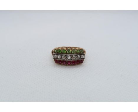 An 18ct yellow gold (hallmarked) ring with diamond, peridot and rubies - ring size P - weight approx 5.8 grams 